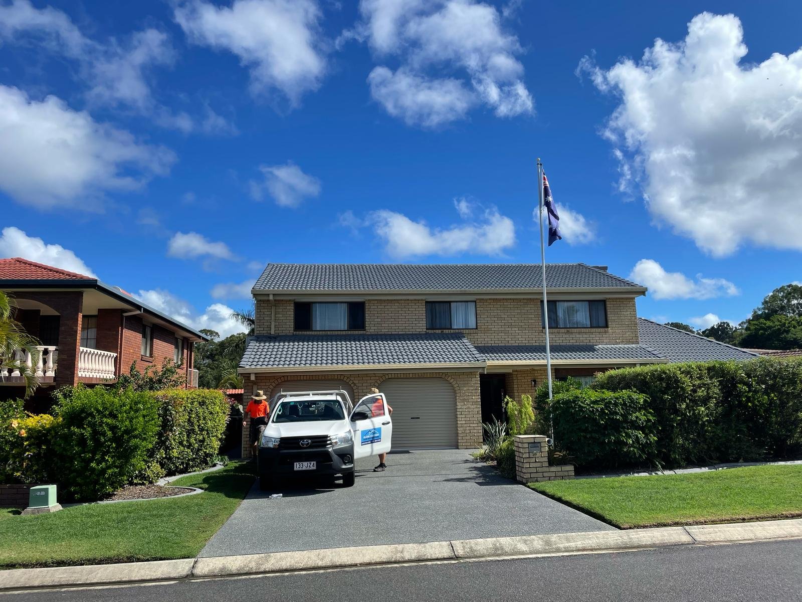 Brisbane home with a clean concrete driveway after pressure cleaning and sealing