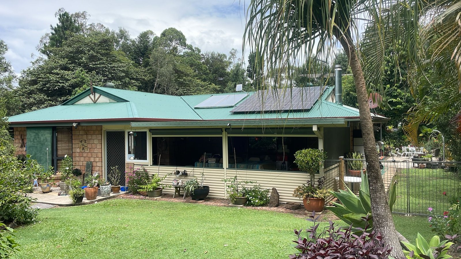 Brisbane home with a clean concrete driveway after pressure cleaning and sealing
