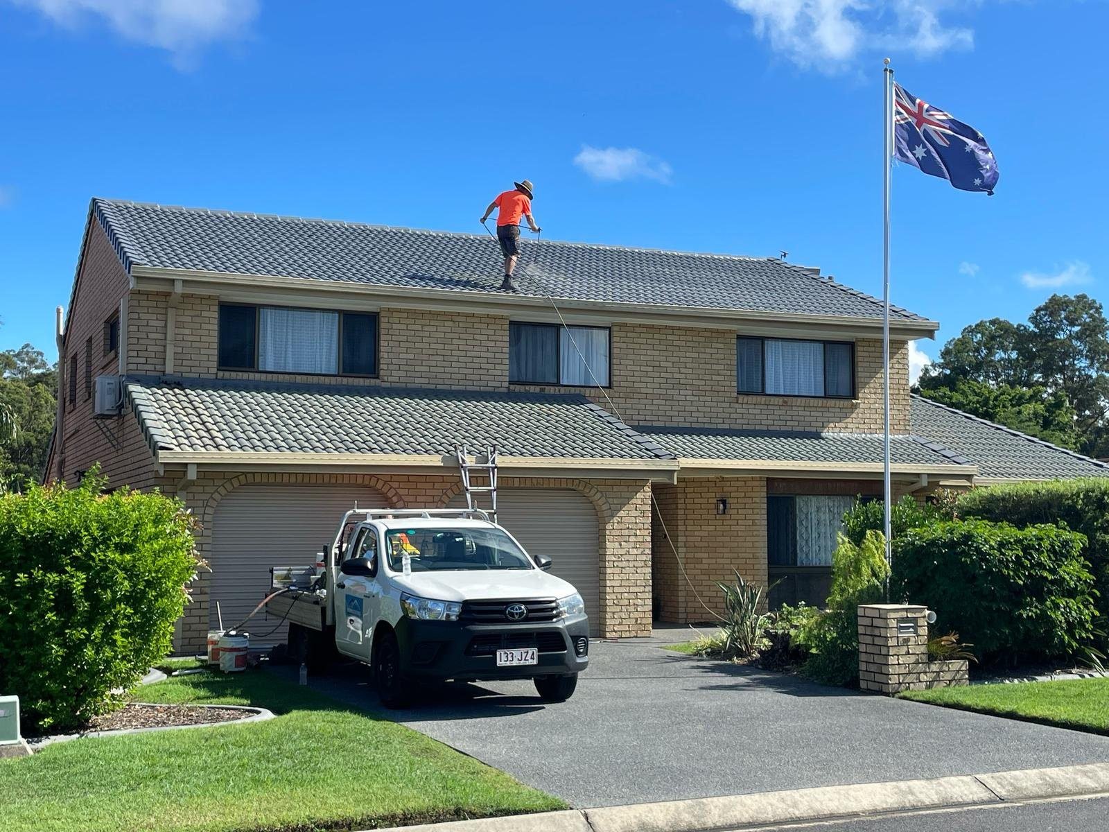 Brisbane home with a clean concrete driveway after pressure cleaning and sealing